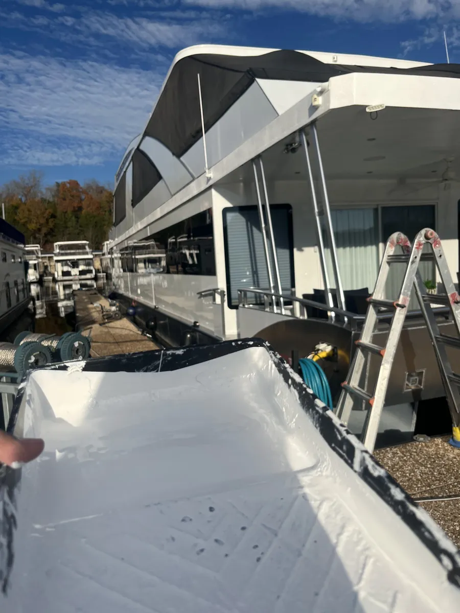 Completed houseboat exterior restoration docked at the marina by Nations RV & Marine